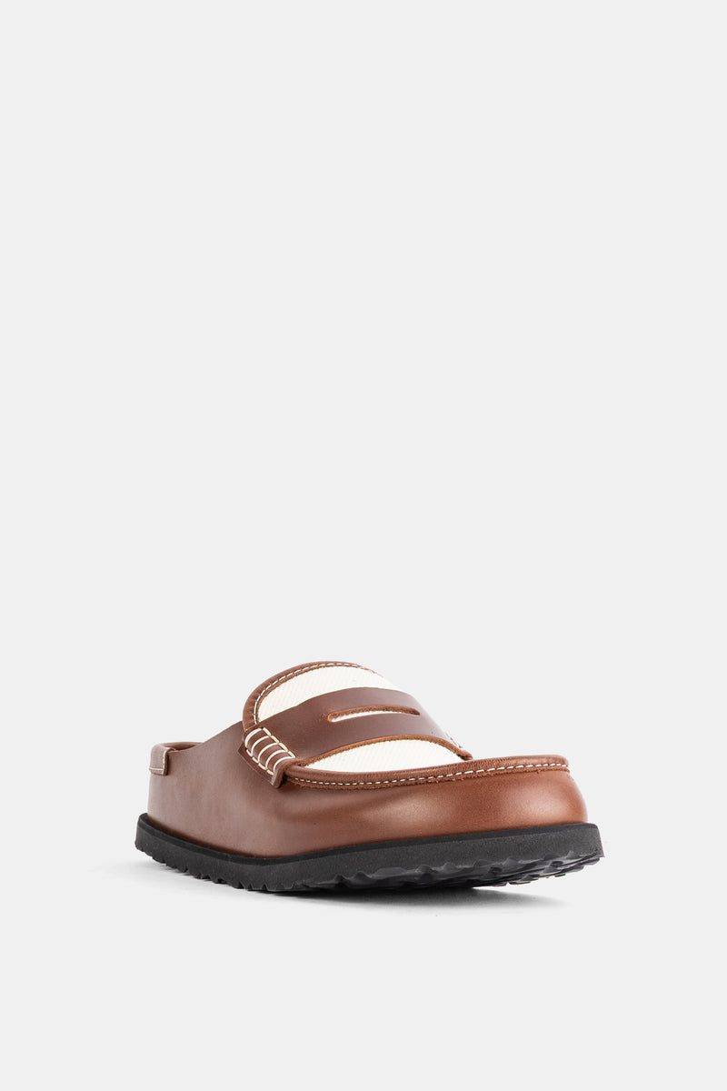 Birkenstock 1774 Naples damesmule in driekwartprofiel met een zwarte profielzool en opvallende witte stiksels.