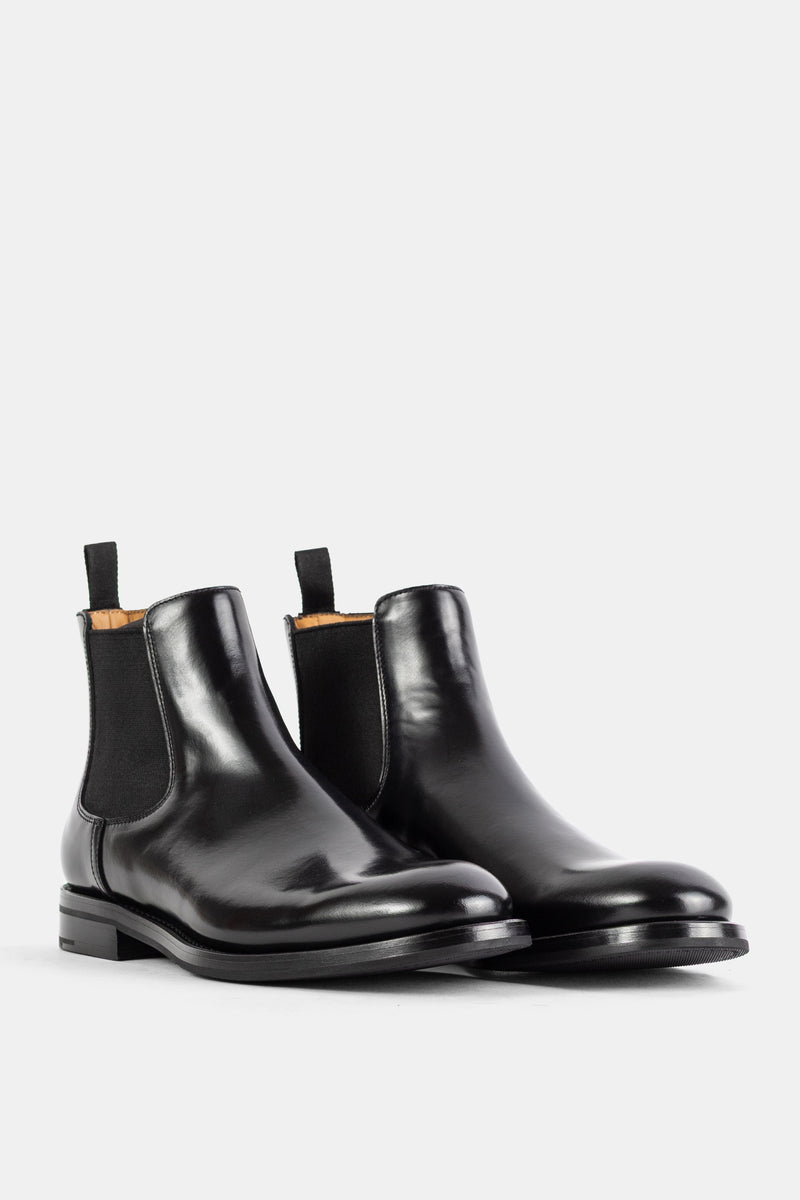 Church's Monmouth paire de bottines Chelsea noires, reflets brillants sur cuir poli, tirettes tissu noir, vue trois quarts