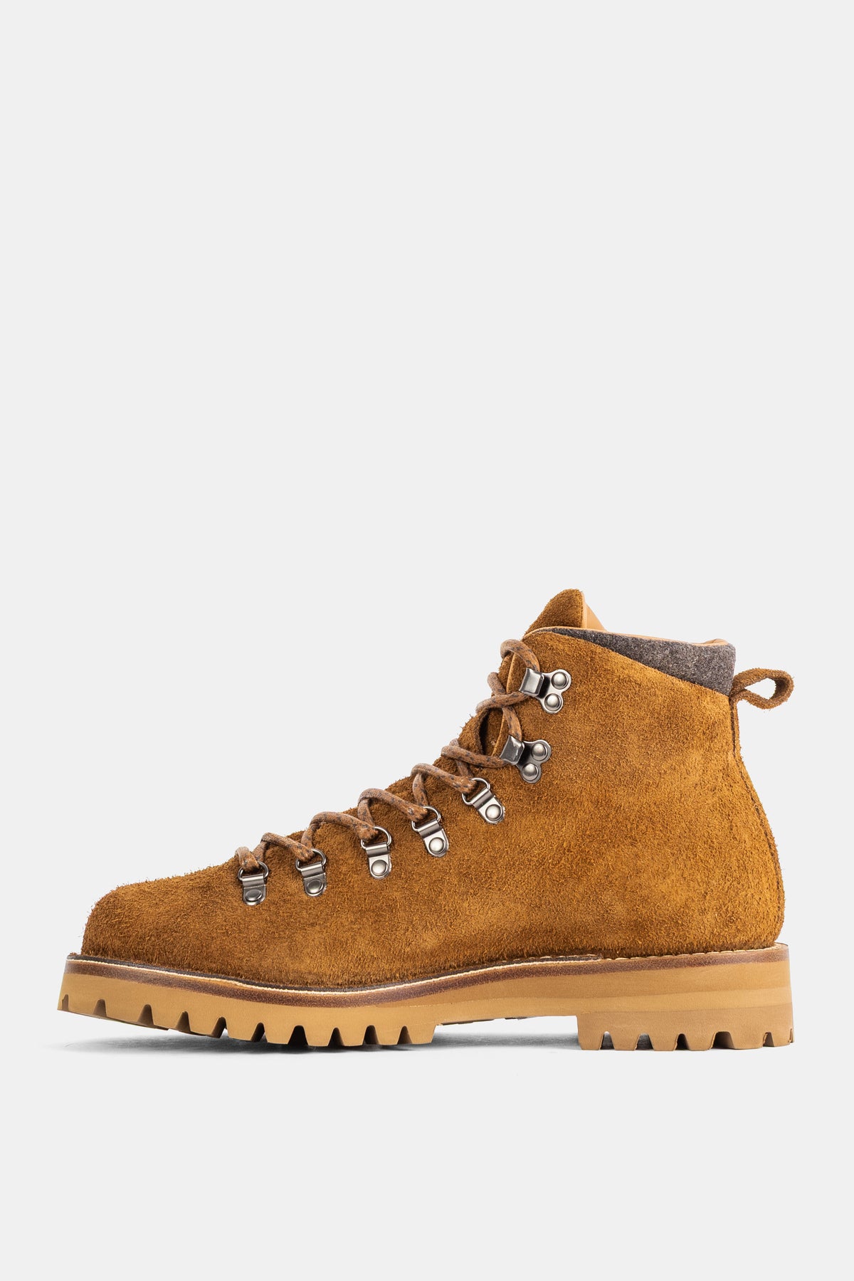 Side view of Church's men's boot in ochre suede, featuring a gray felt collar and a natural rubber lug sole.