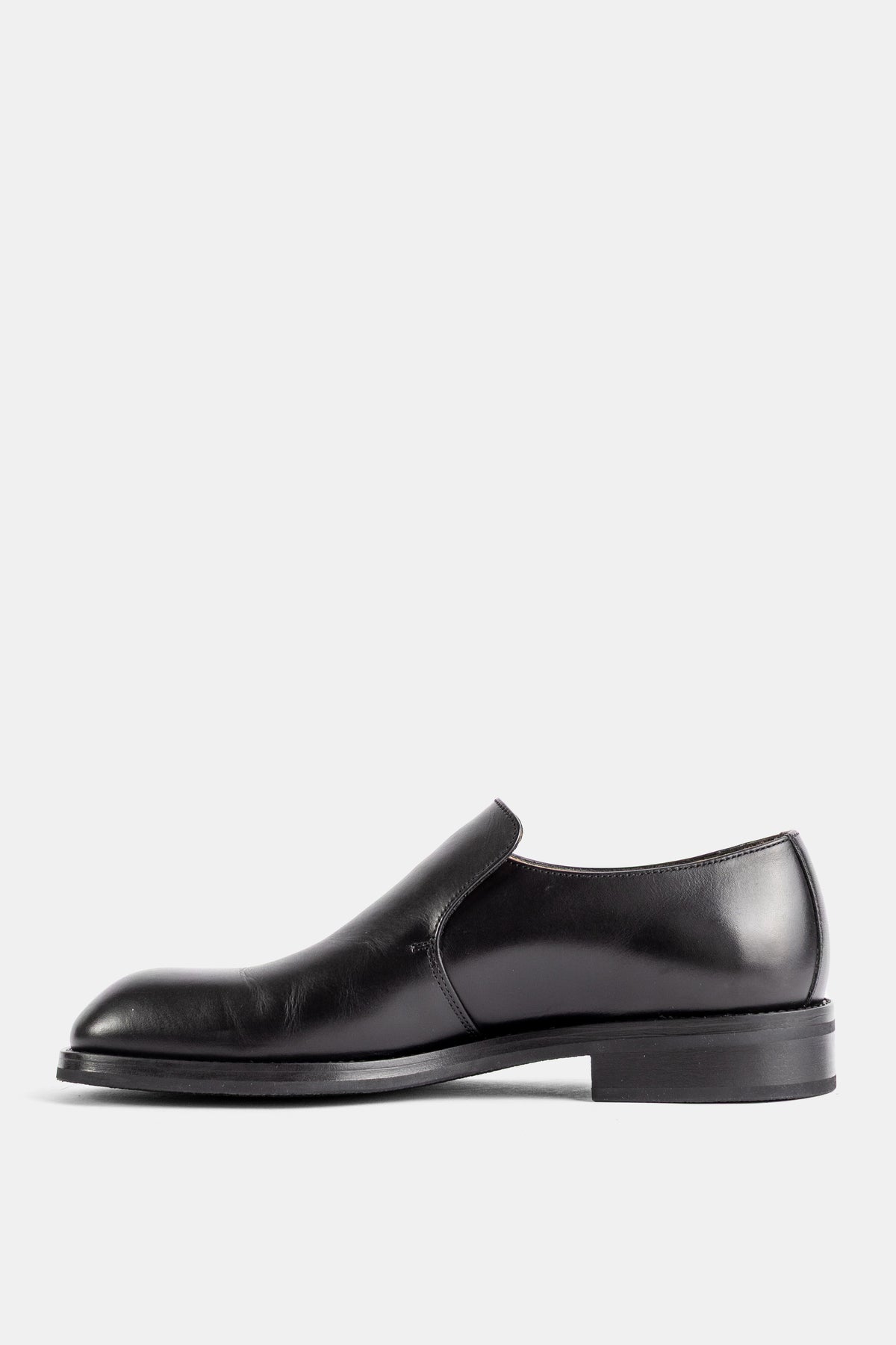 Lemaire slip-on formel cuir végétal noir brillant vue latérale gauche tige monobloc lisse semelle fine noire