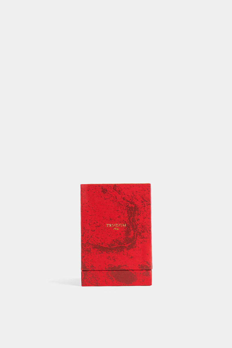 Front view of Trudon Midnight Omen perfume box, a matte marbled-effect red cardboard case with gold inscription