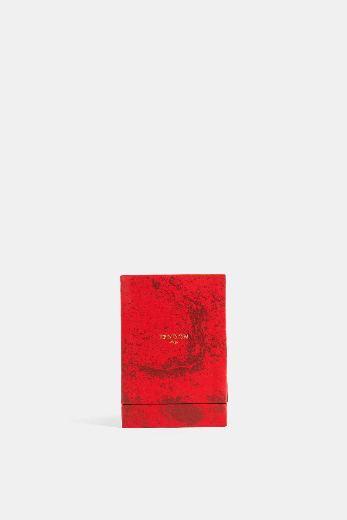 Trudon Mystique bright red lacquered box with a marbled effect and gold lettering, closed front view