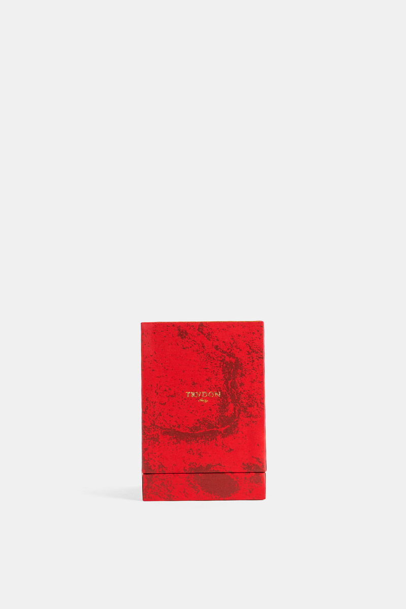Trudon Mystique bright red lacquered box with a marbled effect and gold lettering, closed front view