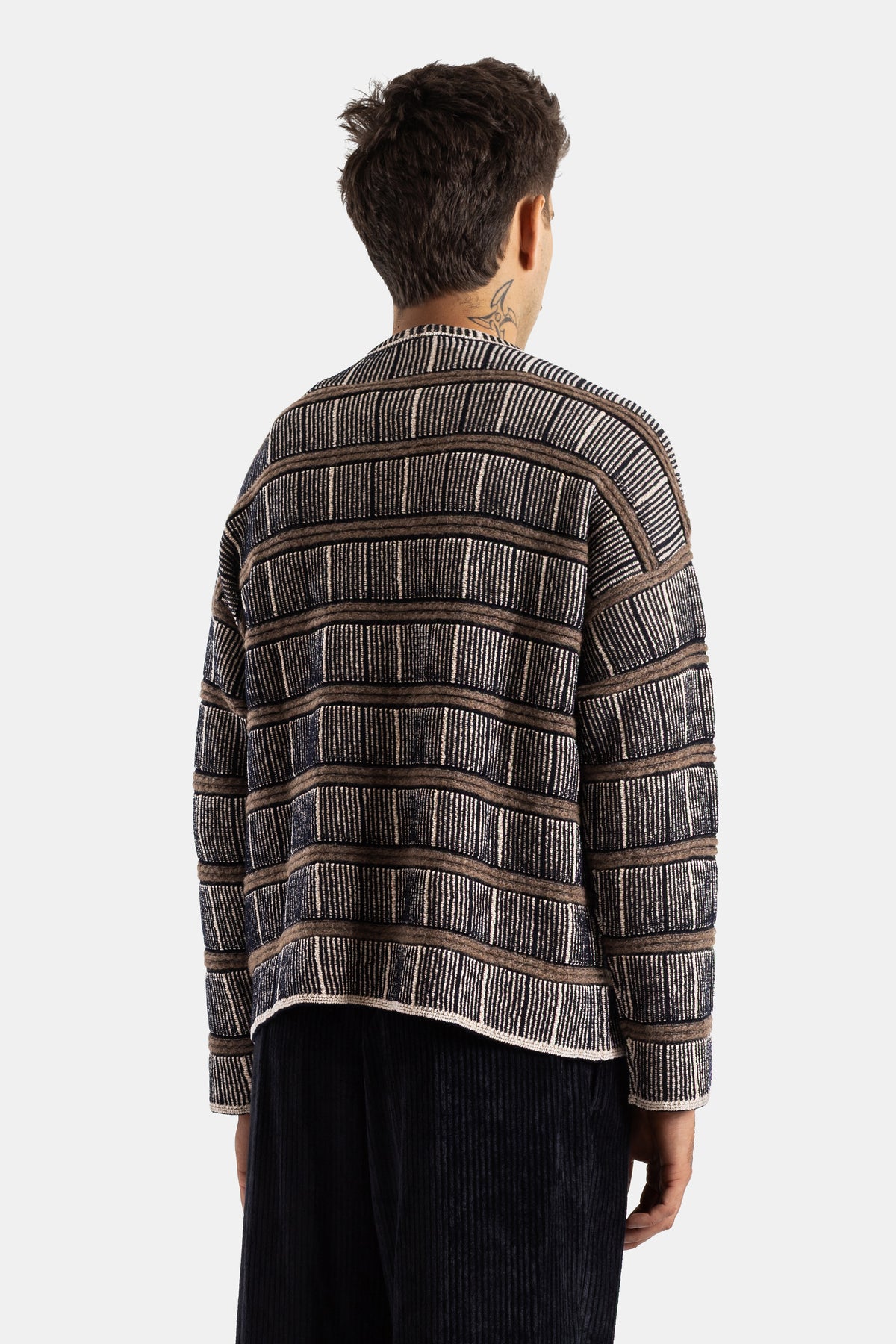 Giorgio Armani boxy striped silk wool sweater in brown, black and white, back view with neck tattoo.