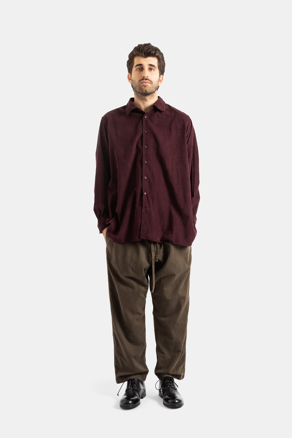 Casey Casey Tie Me Up trousers full look front view wearing burgundy shirt and wide-leg khaki cotton pants.