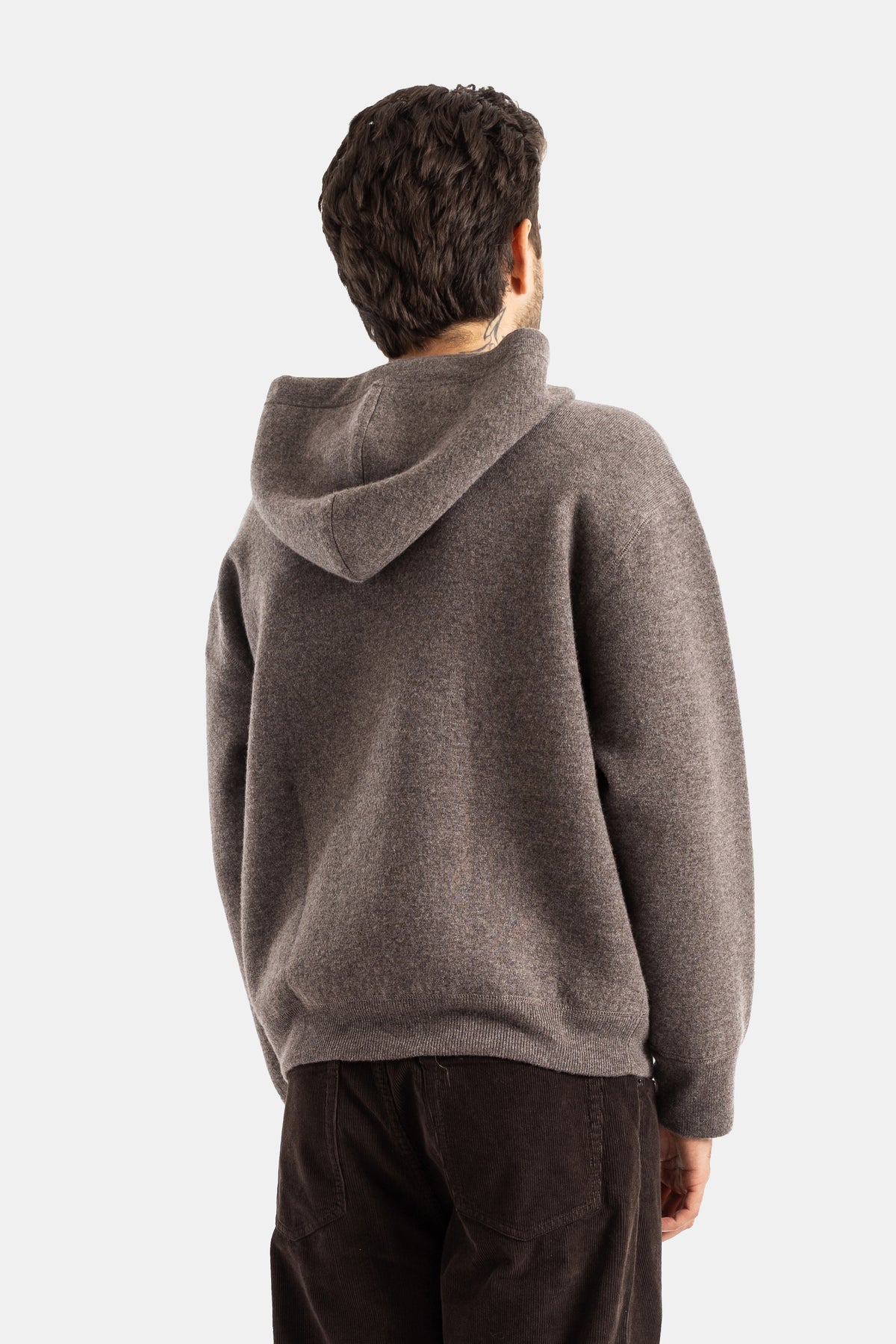 Studio Nicholson Kaschmir-Hoodie in Taupe in Rückansicht, strukturierte Rückenpartie und fallende Kapuze.