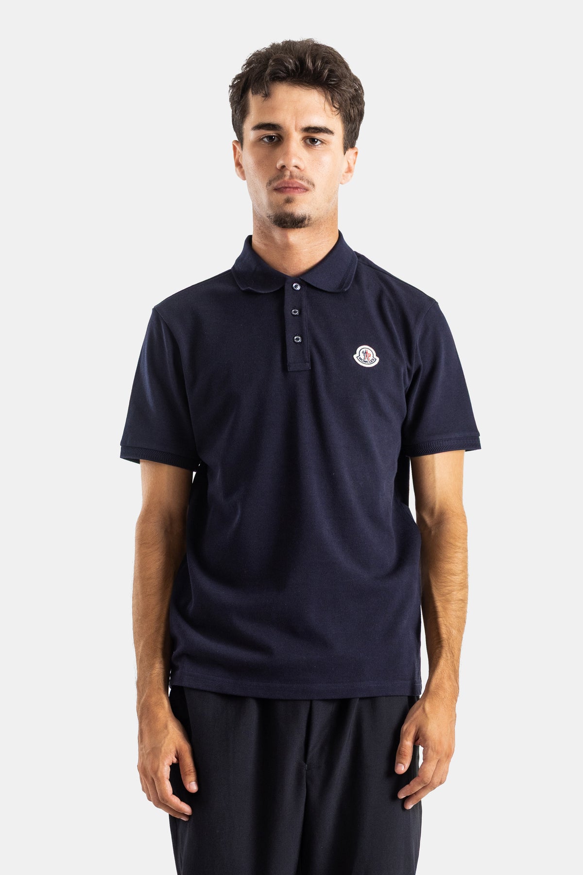 Moncler men's navy blue cotton piqué polo shirt, slim fit, polo collar, short sleeves and embroidered logo.