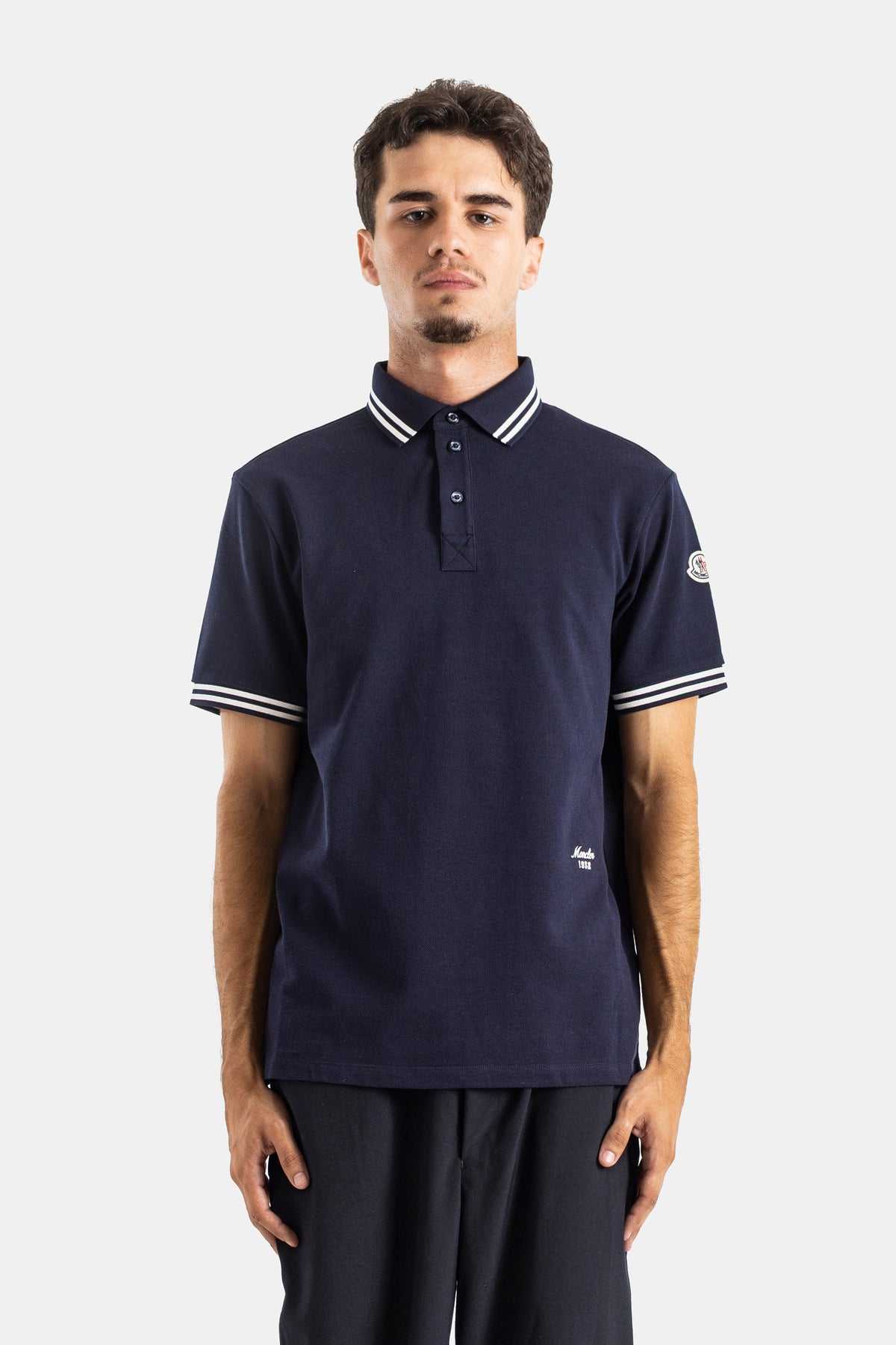 Moncler navy blue short-sleeve polo shirt in cotton piqué, straight fit with a white striped tipped collar.