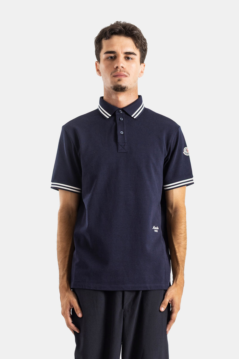 Moncler navy blue short-sleeve polo shirt in cotton piqué, straight fit with a white striped tipped collar.
