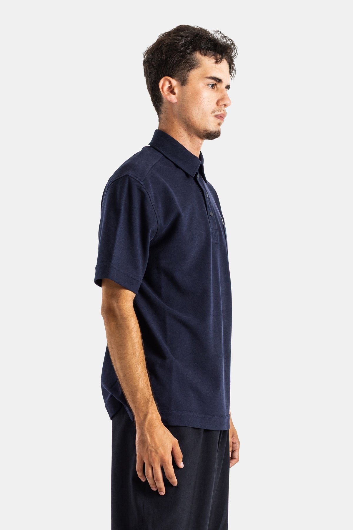 Moncler polo homme vue profil droit tissu piqué bleu nuit coupe oversize bande côtelée ourlet