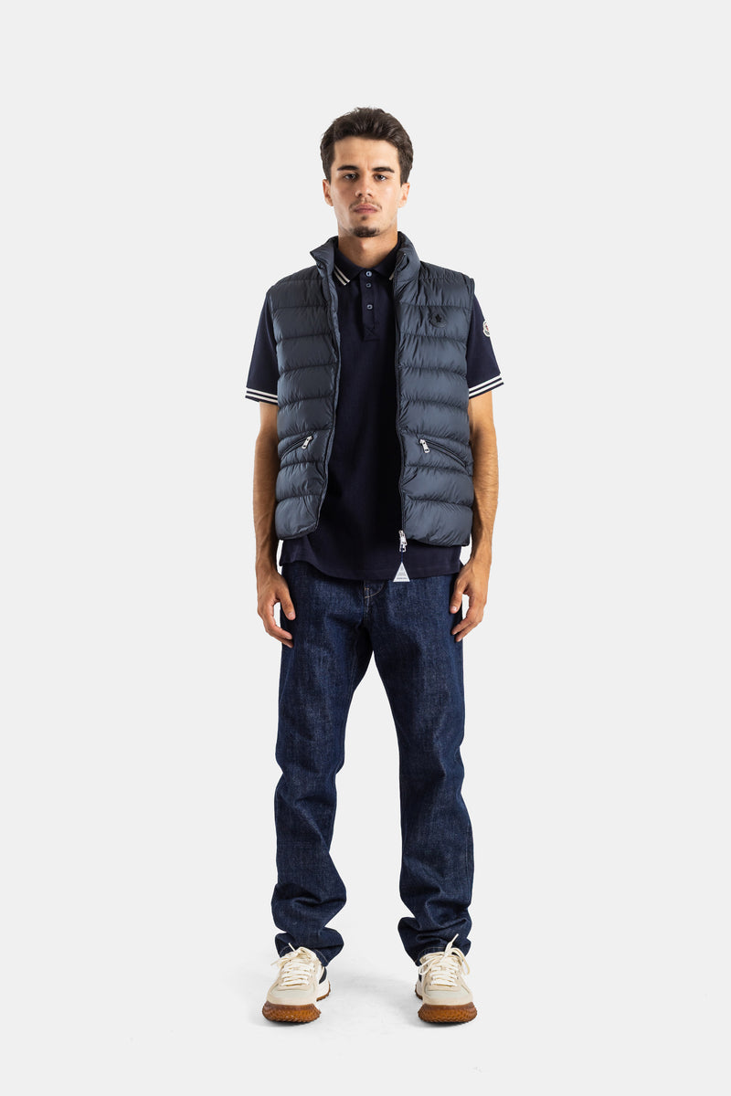 Moncler Treompan total navy look with men's fitted down vest and a polo shirt featuring contrasting stripes.