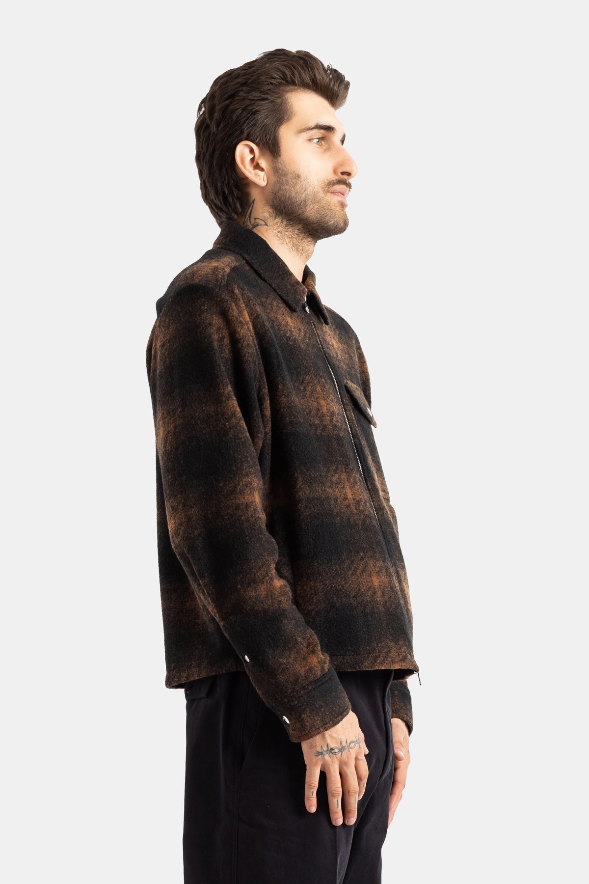 Moncler men's wool plaid jacket profile view, long sleeves with buttoned cuffs and visible front zipper.