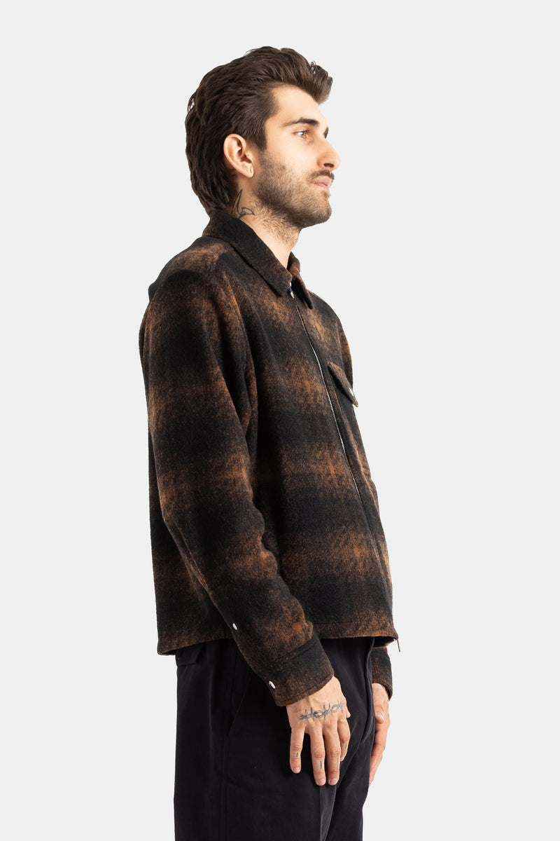 Moncler men's wool plaid jacket profile view, long sleeves with buttoned cuffs and visible front zipper.