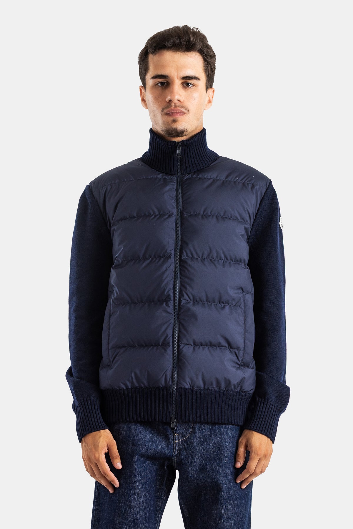 Navy blue Moncler men's hybrid quilted cardigan featuring a high collar and warm ribbed knit sleeves.