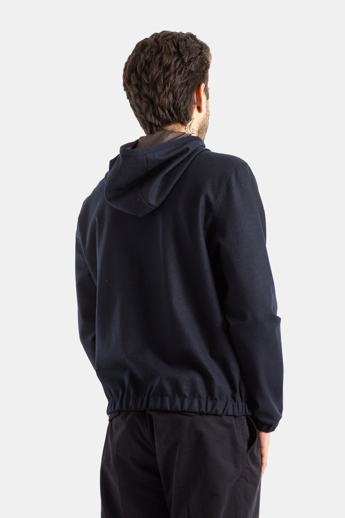 Moncler men's navy blue wool hooded jacket, back view with an elasticated hem and contrast inner collar