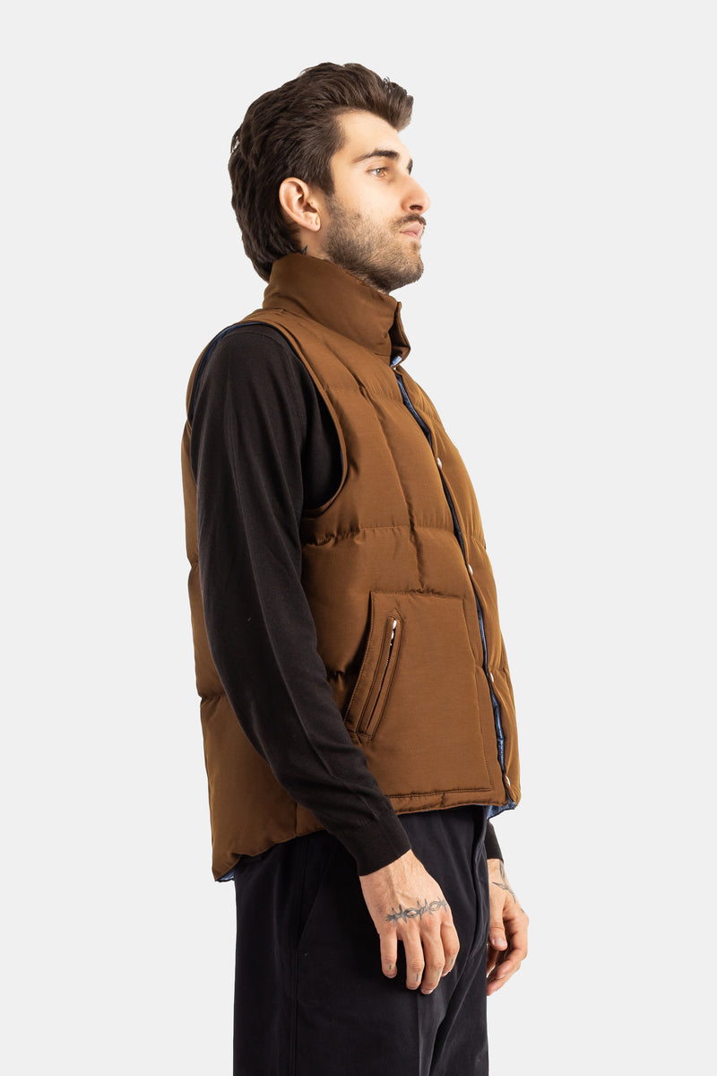 Moncler Brumelune brown sleeveless down gilet side profile view with zipped pocket and visible blue lining