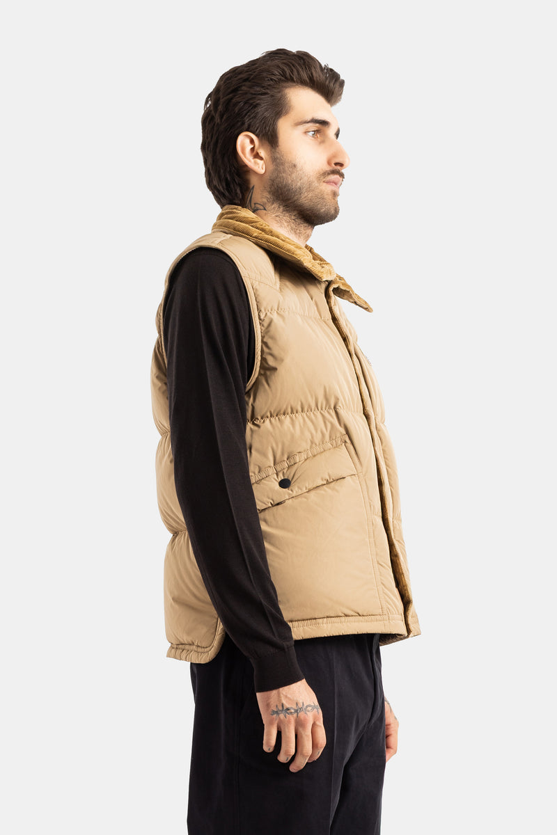Moncler Grenoble men's Evans beige quilted vest in profile view, buttoned chest pocket, gold corduroy collar.