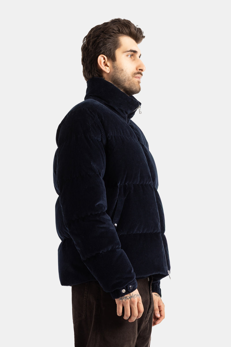 Piumino Moncler Esparron uomo vista di profilo in velluto a coste blu marina trapuntato con maniche a palloncino