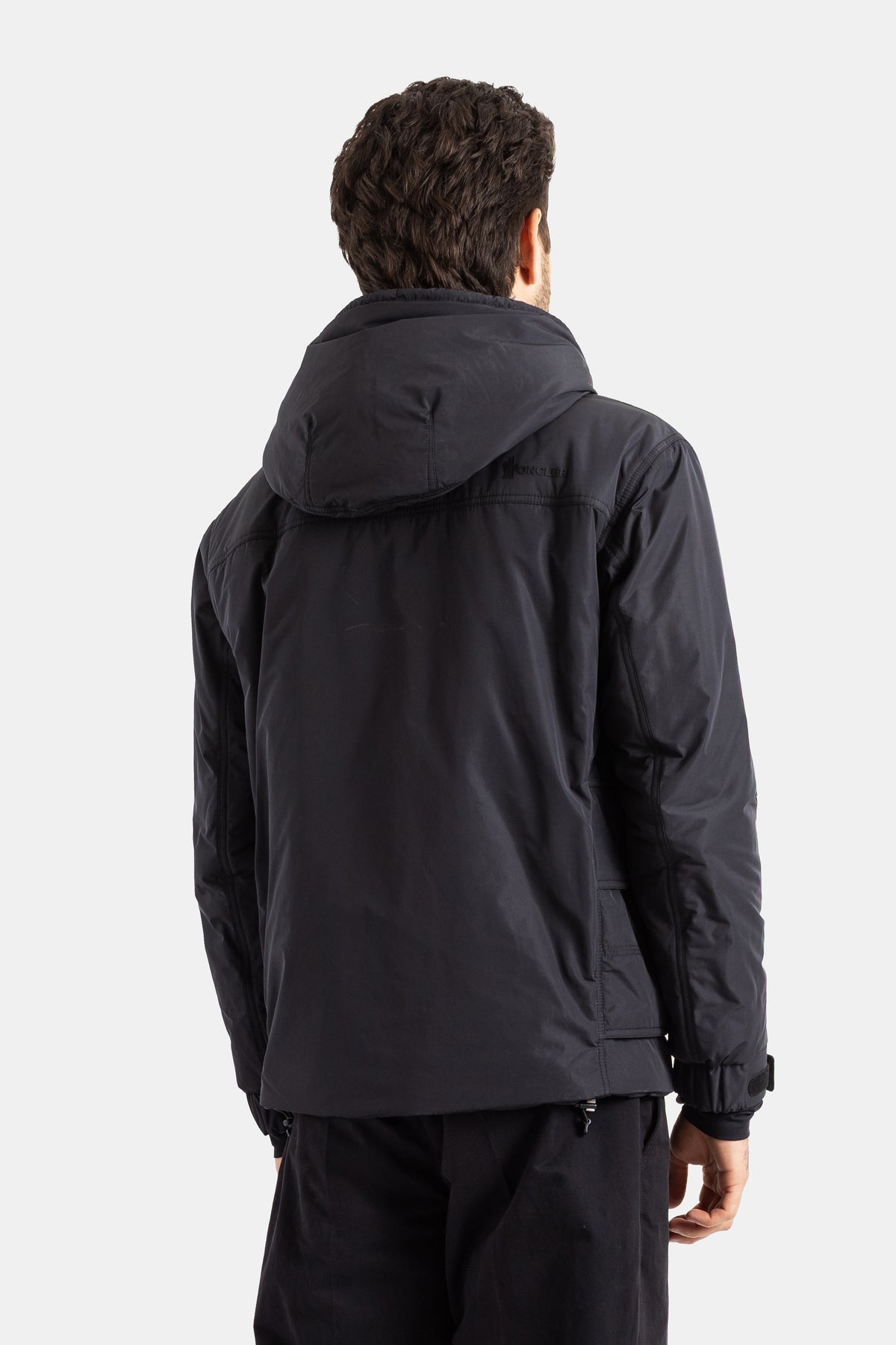Moncler Grenoble men's Ober jacket back view showing bulky hood, tone-on-tone logo and black stitching.