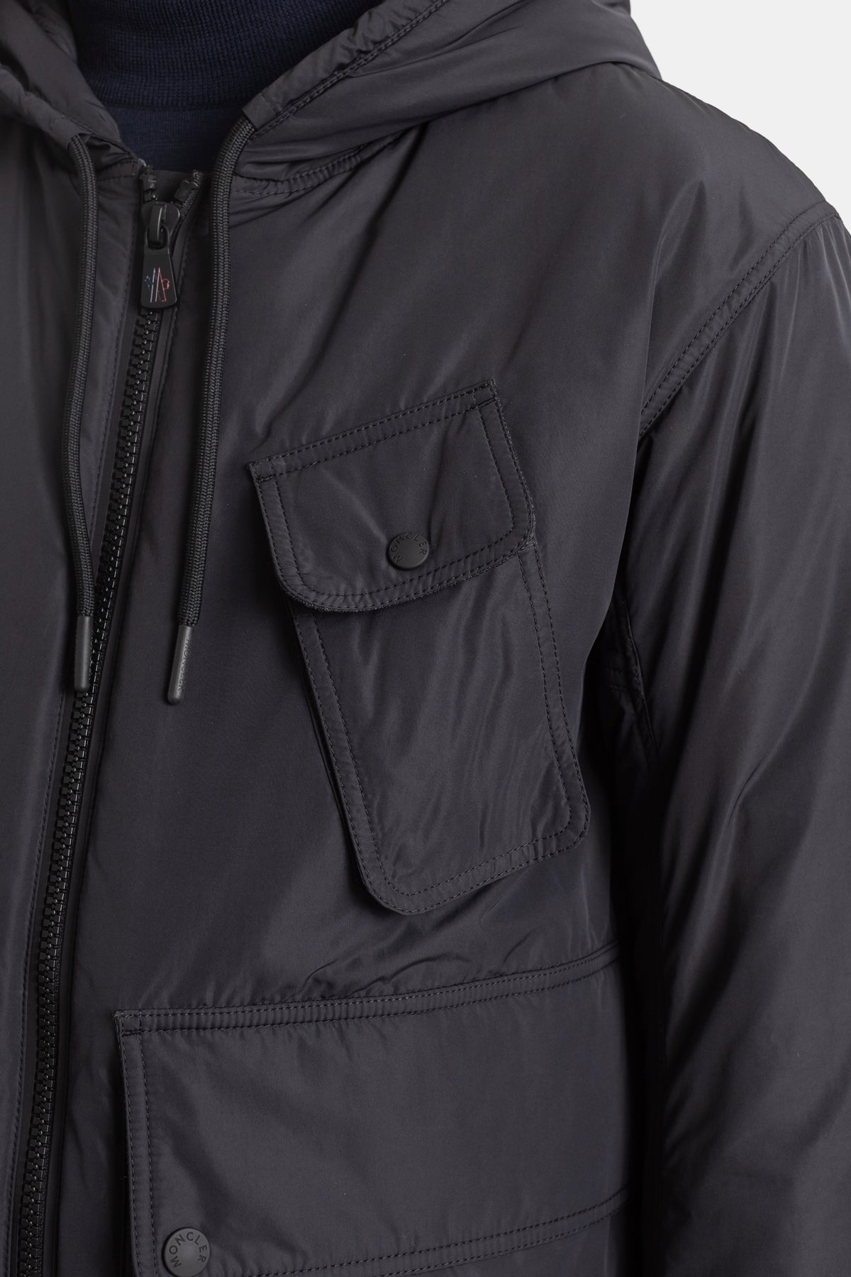 Moncler Grenoble Ober jacket close-up detail showing black cargo chest pocket, press studs and zipper.