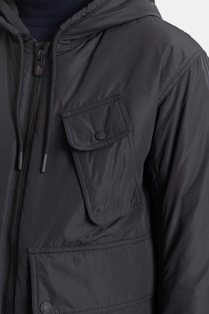 Moncler Grenoble Ober jacket close-up detail showing black cargo chest pocket, press studs and zipper.