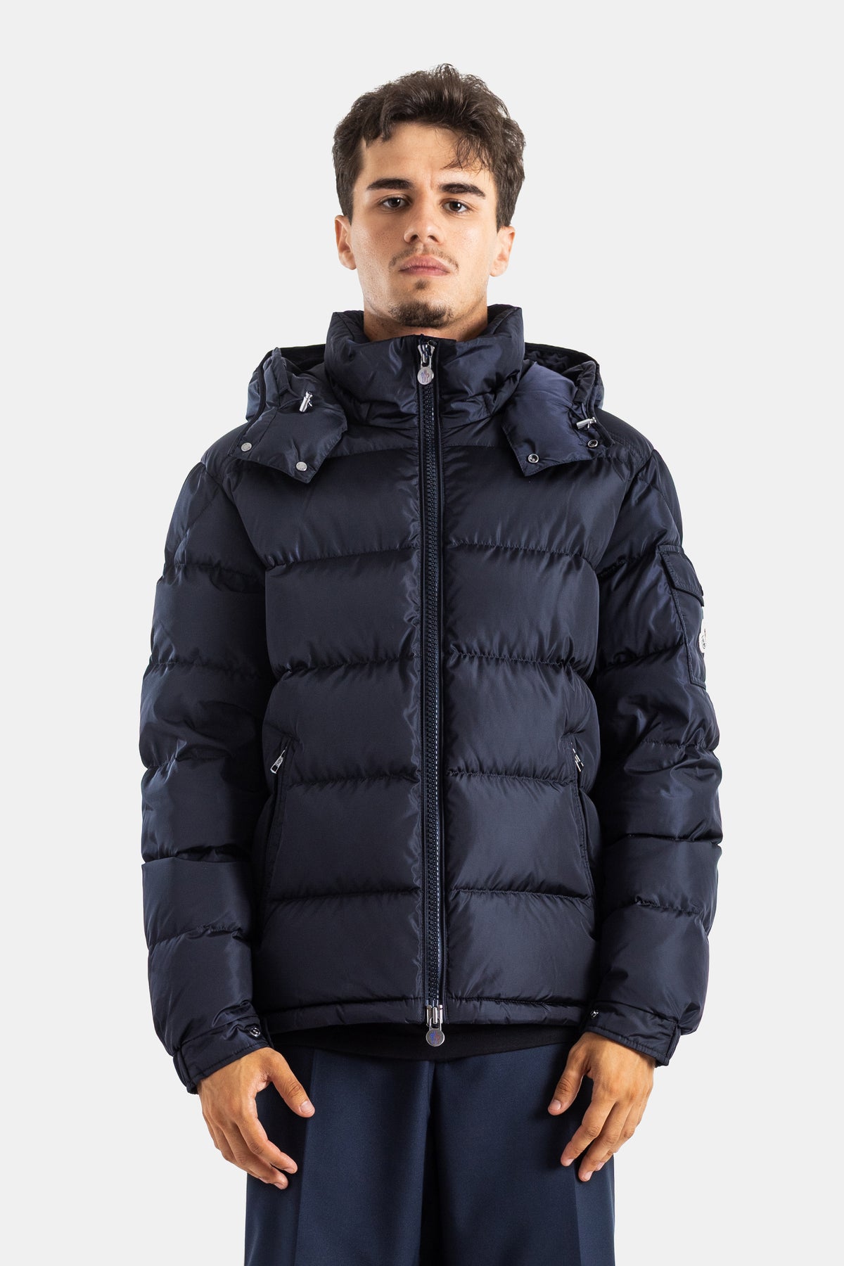 Moncler Maya short men's down jacket in matte navy blue featuring a structured hood and cozy enveloping cut.