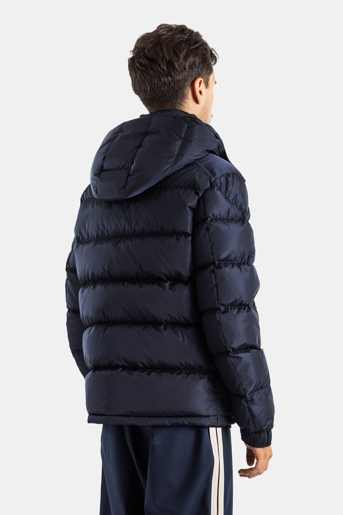 Back view of Moncler Maya short matte navy blue down jacket with padded structured hood and elasticated cuffs.