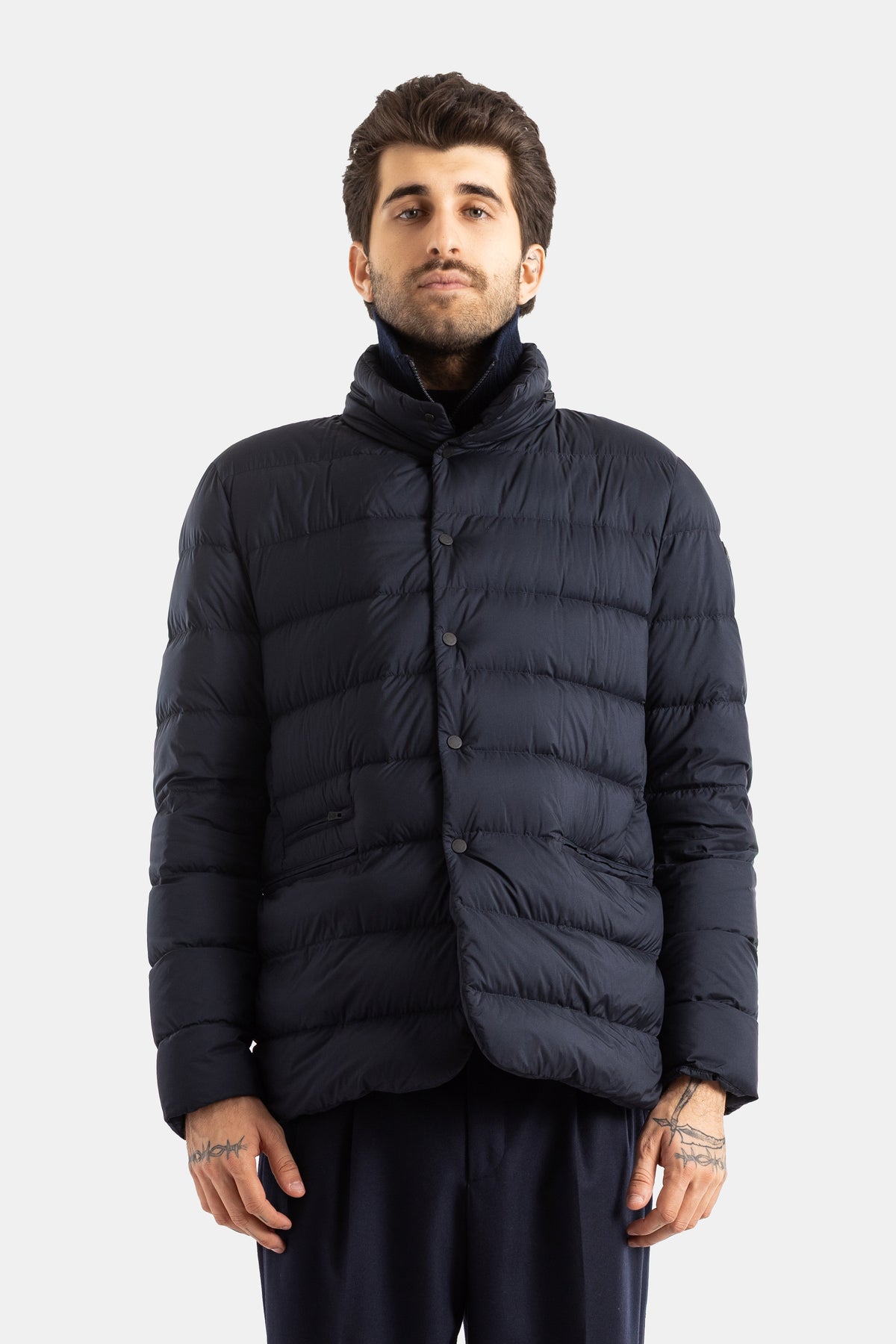 Moncler Elarune men's short down jacket with high collar and structured asymmetrical fit in navy blue.