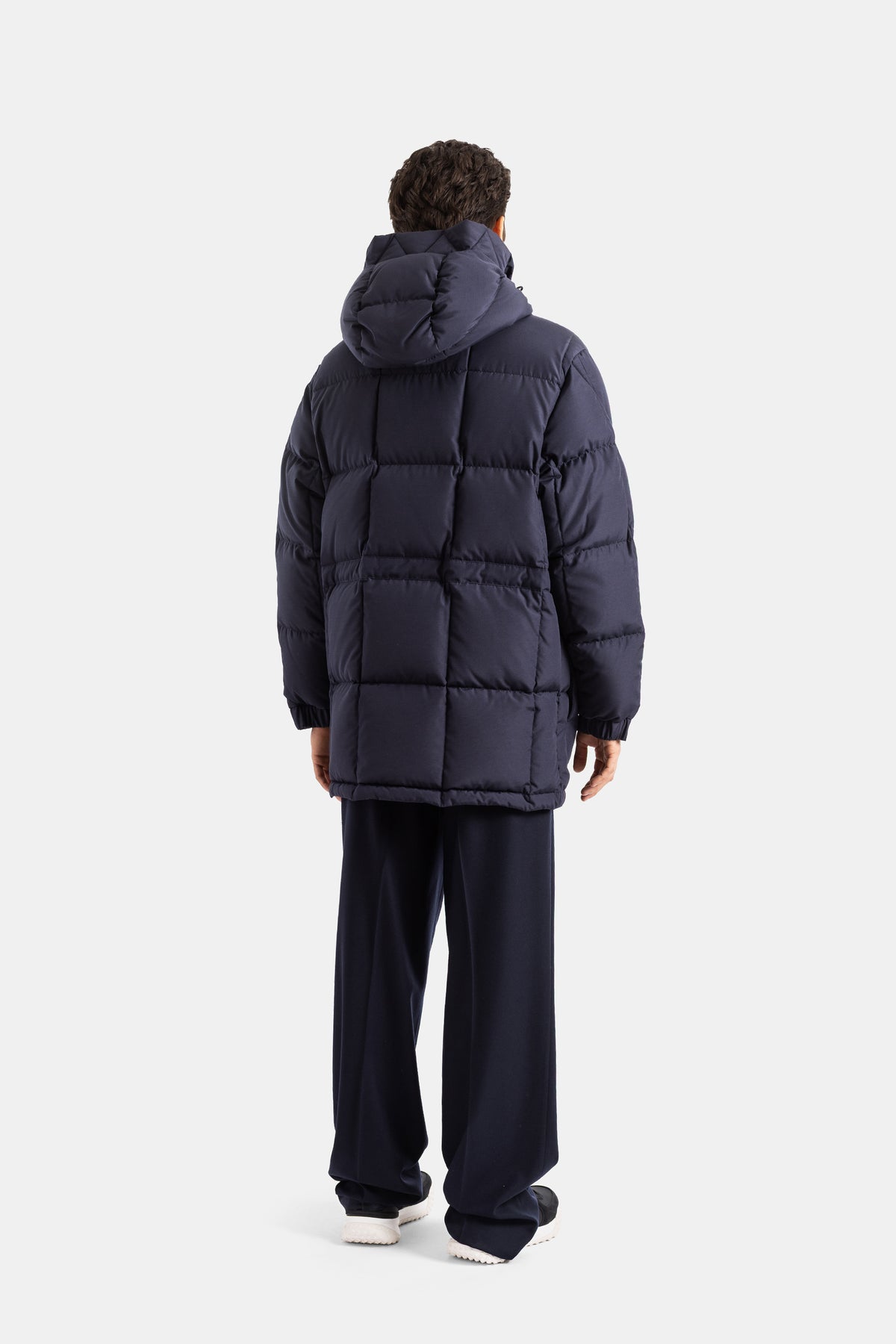 Moncler Sylmara back view of men's long down jacket in navy blue with square quilting and a voluminous hood