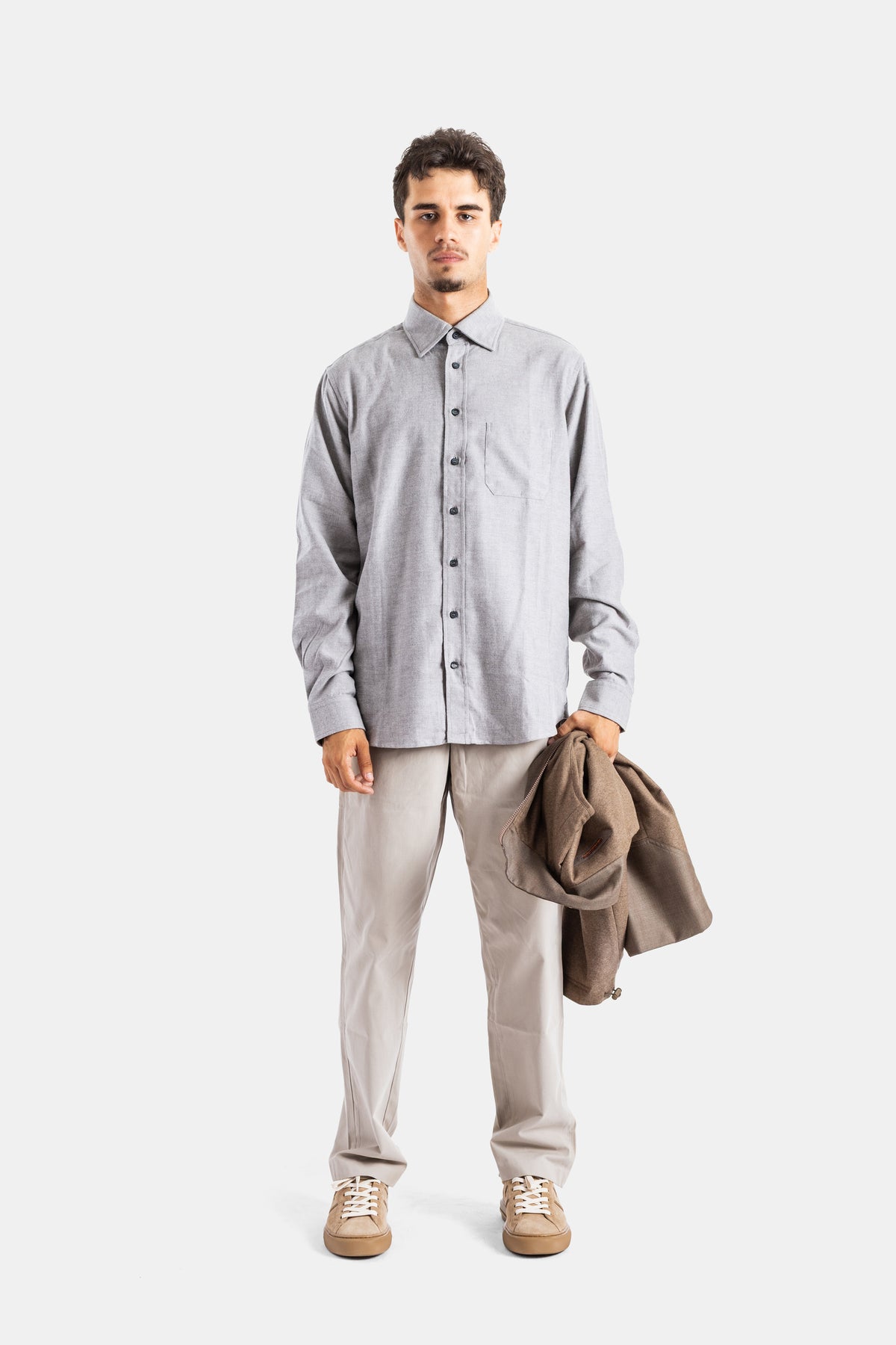 Sease men's grey flannel shirt worn with beige trousers and sneakers, creating a chic and casual style.