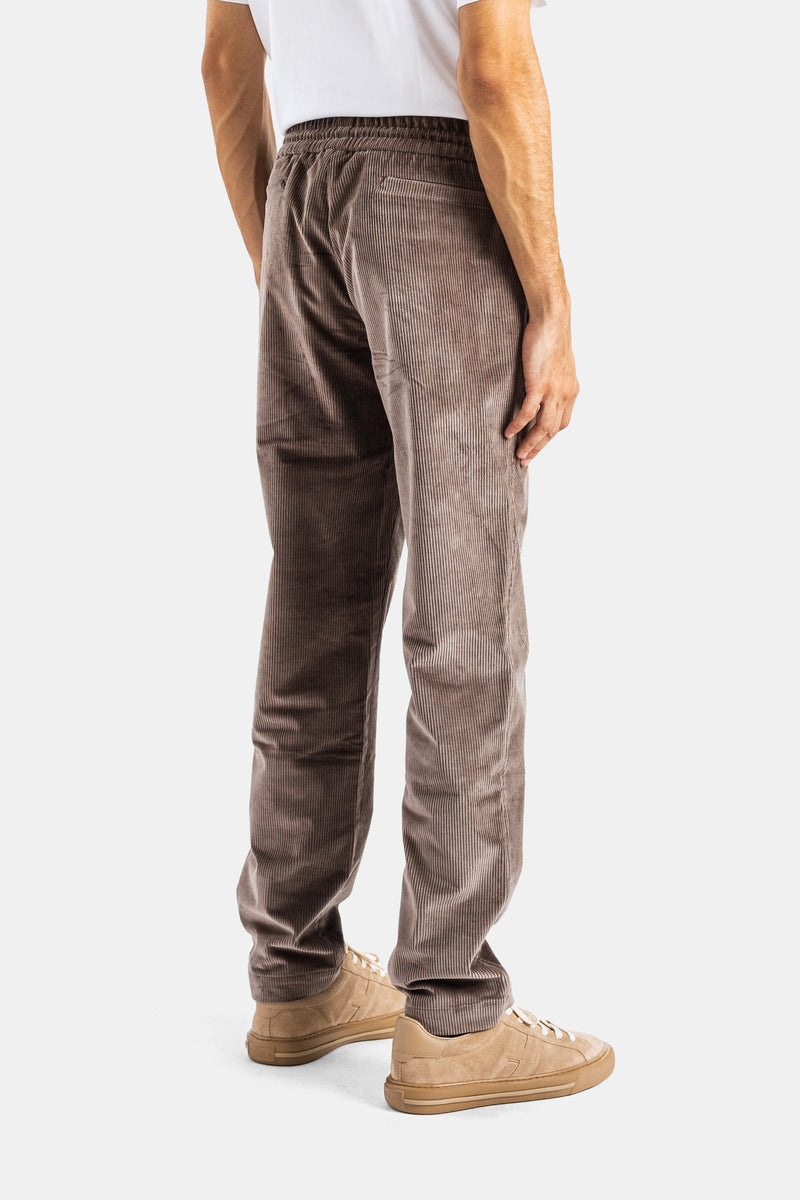 Sease Mindset taupe corduroy trousers from the back showing elasticated waist and beige suede sneakers