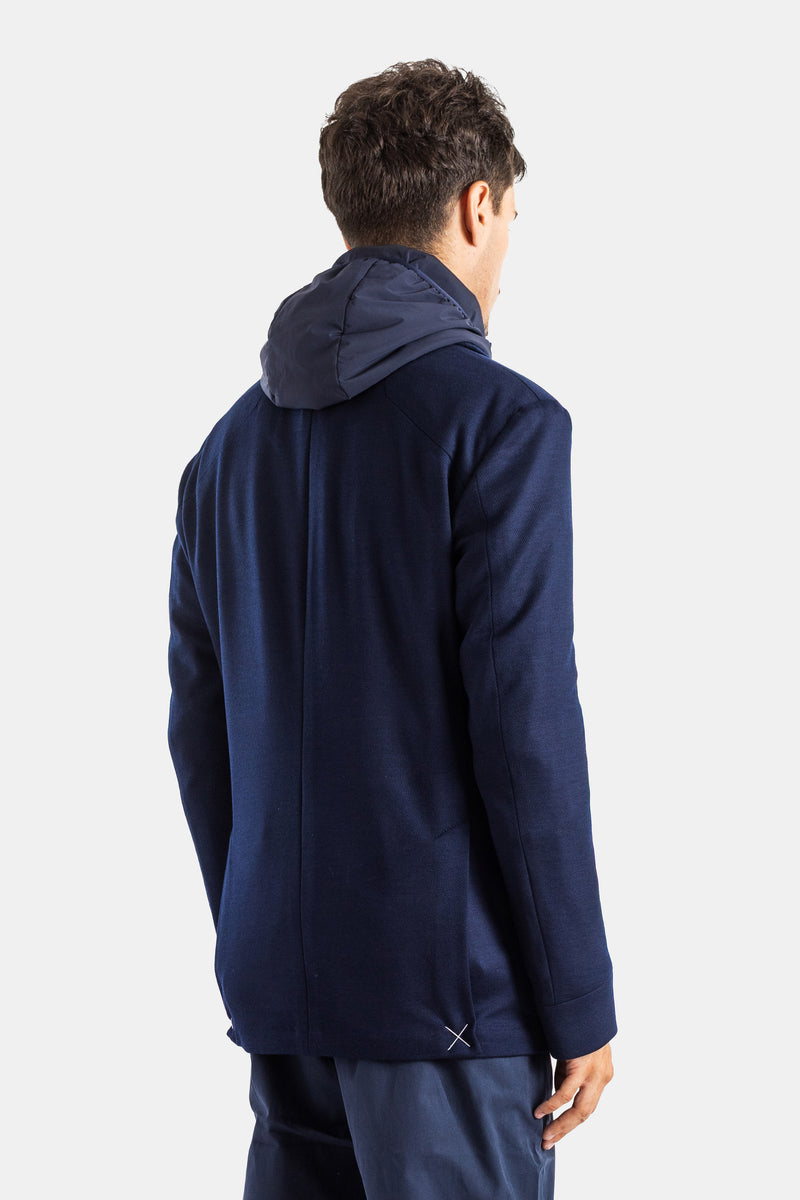 Rear view of Sease men's navy hybrid blazer, showing the contrasting nylon hood and technical raglan seams.
