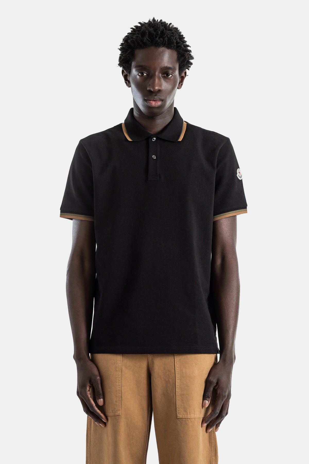 Moncler black piqué cotton polo shirt camel trim collar and cuffs logo patch sleeve men SS26