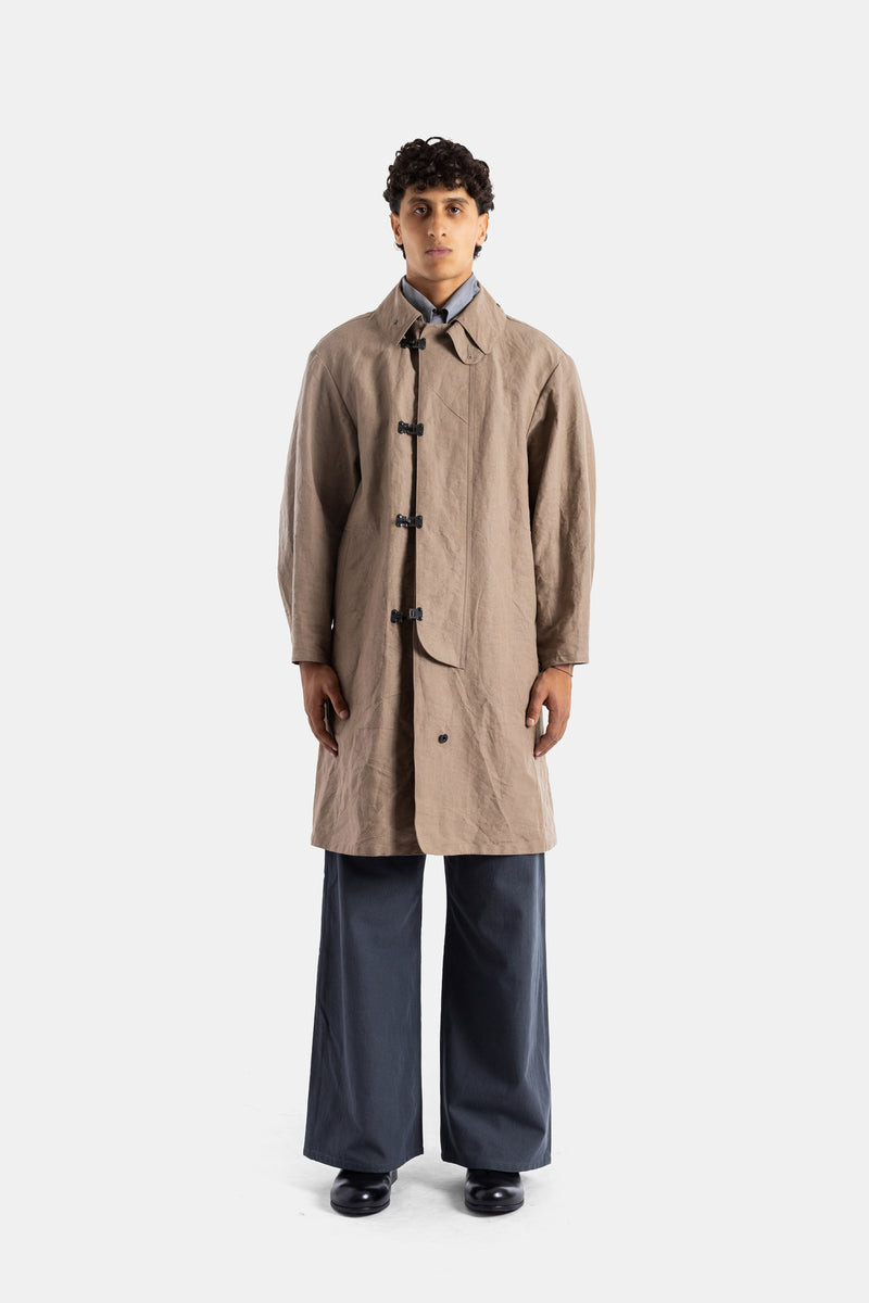 Taiga Takahashi beige washi linen raincoat oversized fit fluid drape black clip closures long men's silhouette SS26