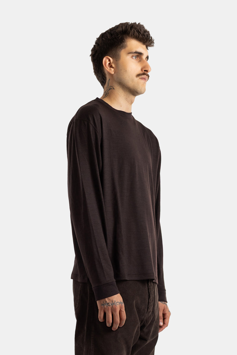 Left profile view of the men's Studio Nicholson long-sleeved Pinhas t-shirt in a relaxed dark brown fit.