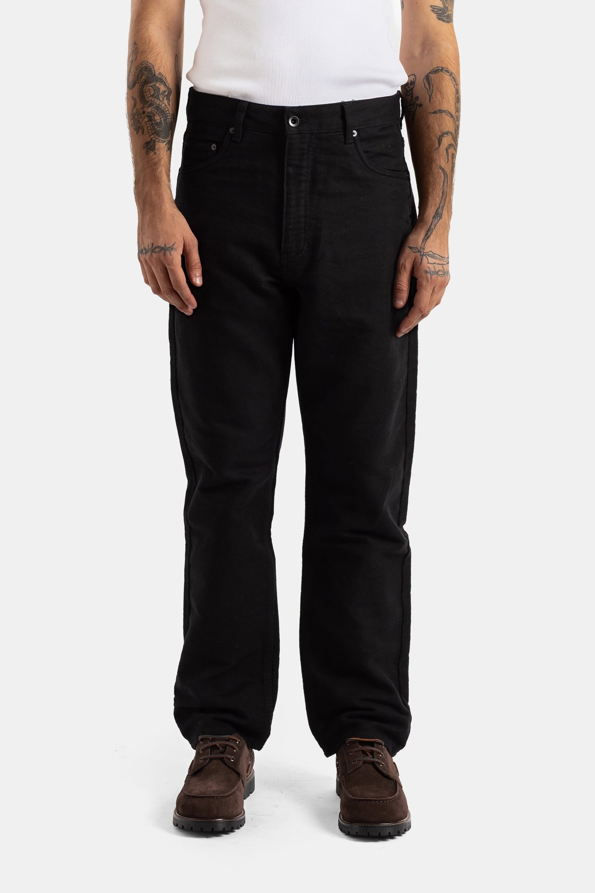 Studio Nicholson men's loose 90s straight-leg five-pocket jeans made of a dense and deep black denim.