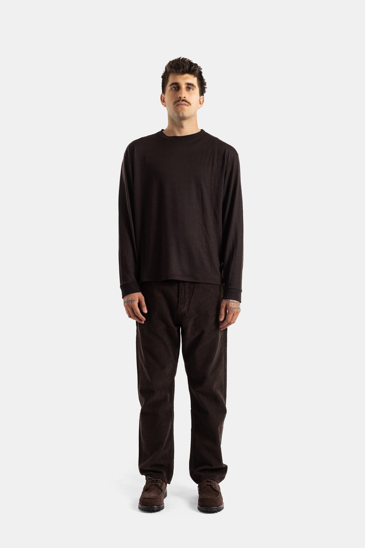 Studio Nicholson brown corduroy trousers in a total chocolate look with a matching oversized long-sleeve sweatshirt.