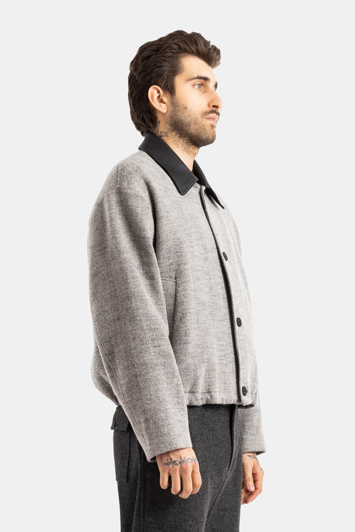 Studio Nicholson veste laine homme profil côté boutons noirs col cuir contrasté coupe oversize décontractée