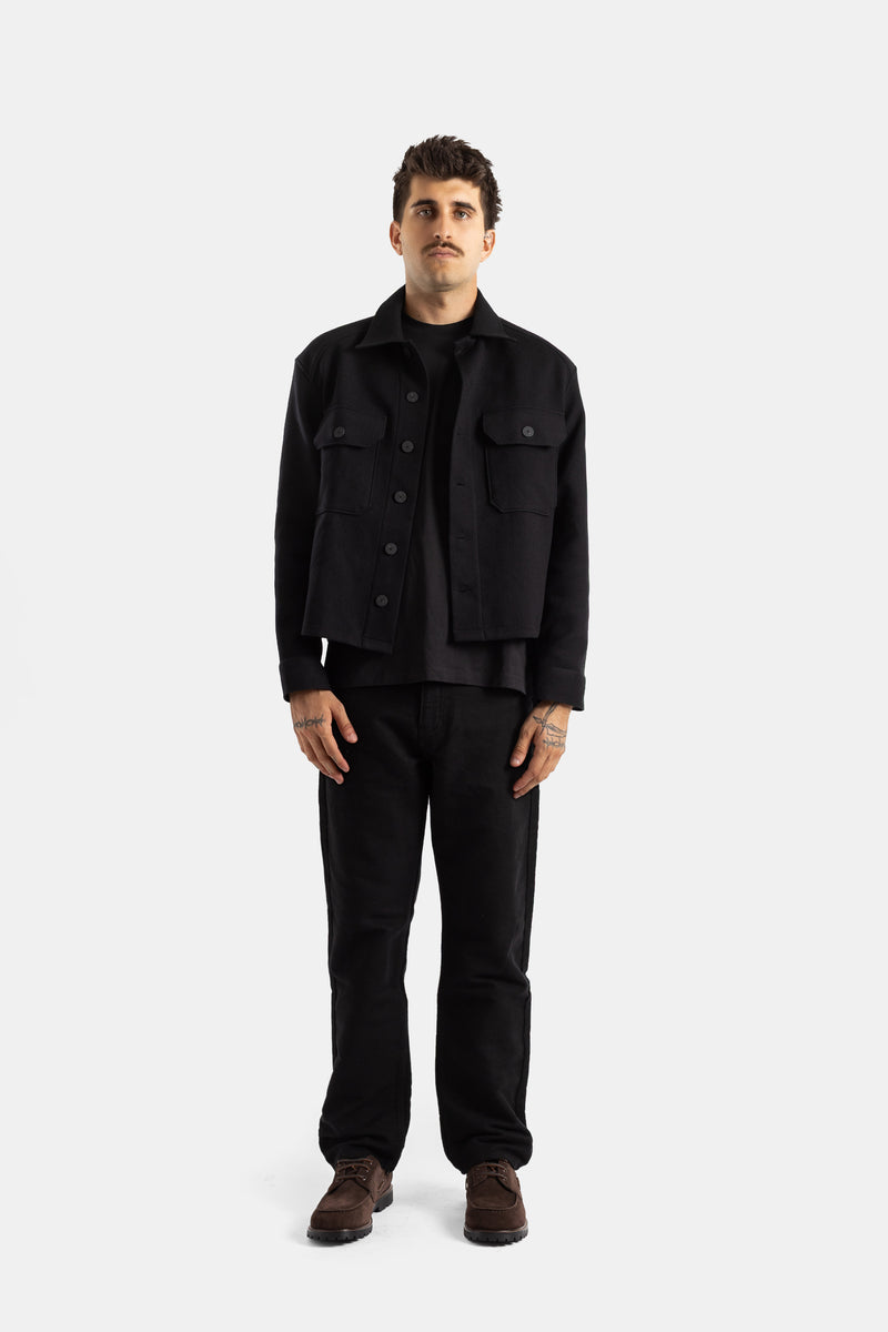 Studio Nicholson Kelver look total black homme veste laine courte portée ouverte sur t-shirt noir et pantalon droit
