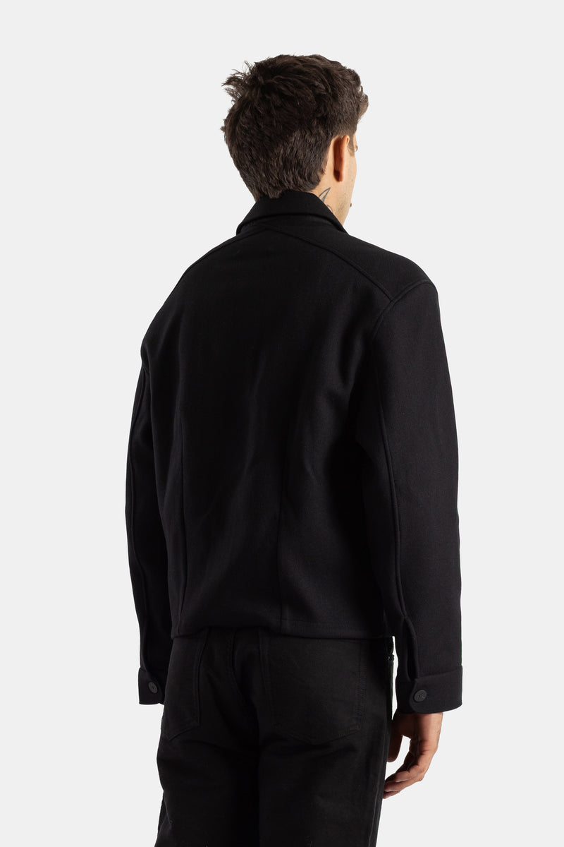Back view of Studio Nicholson Kelver black wool jacket for men featuring structured shoulders and buttoned cuffs