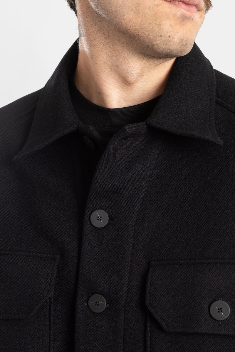 Studio Nicholson Kelver detail of shirt collar on textured black wool with black buttons and round neck layer