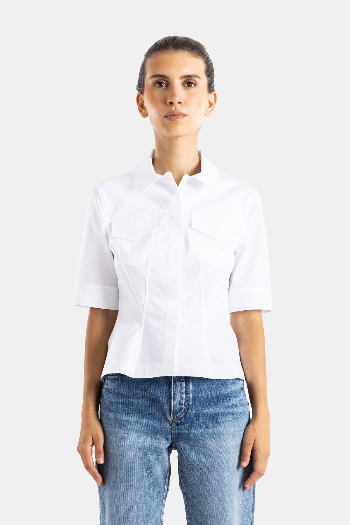 Maison Alaïa top structuré blanc en coton, coupe courte ajustée, col ondulé et manches courtes à revers