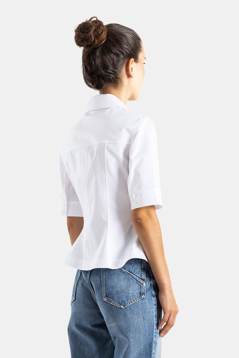 Maison Alaïa chemise coton blanc dos structuré avec coutures verticales cintrées et manches courtes boutonnées