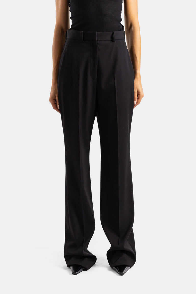 Pantaloni Balenciaga a vita alta con pinces in lana stretch nera, taglio dritto svasato con cintura strutturata.