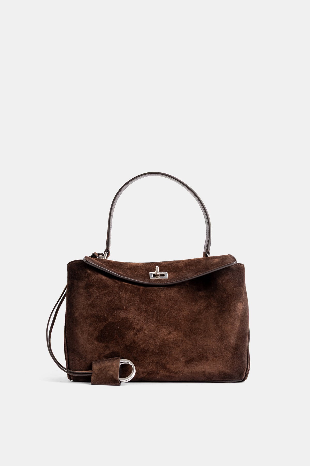 Mala de ombro Balenciaga Rodeo S em camurça aveludada tom castanho-chocolate e fecho rotativo prateado.
