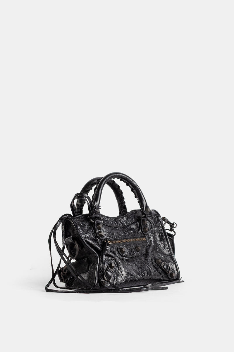 Vista a tre quarti di Balenciaga Le City Mini in pelle nera invecchiata con doppio manico intrecciato e zip dorata.