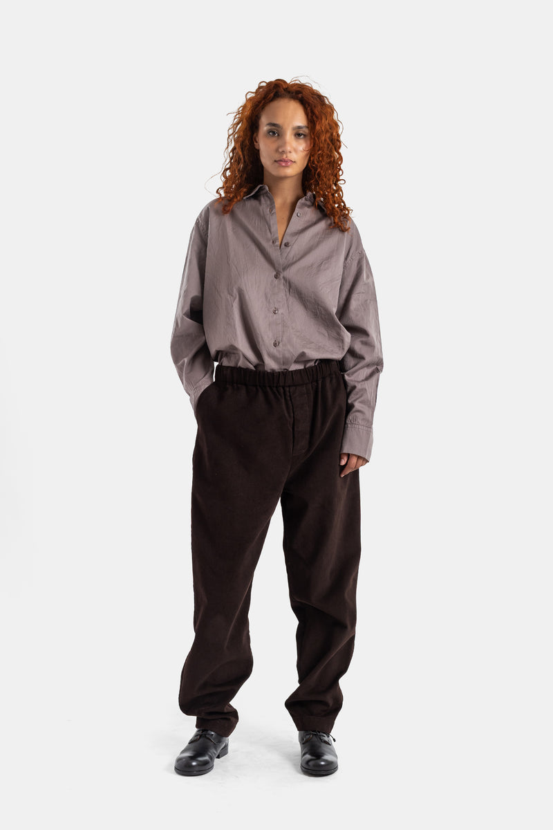 Casey Casey Jog Ah dark brown corduroy trousers styled with a grey oversized shirt, casual women's look.