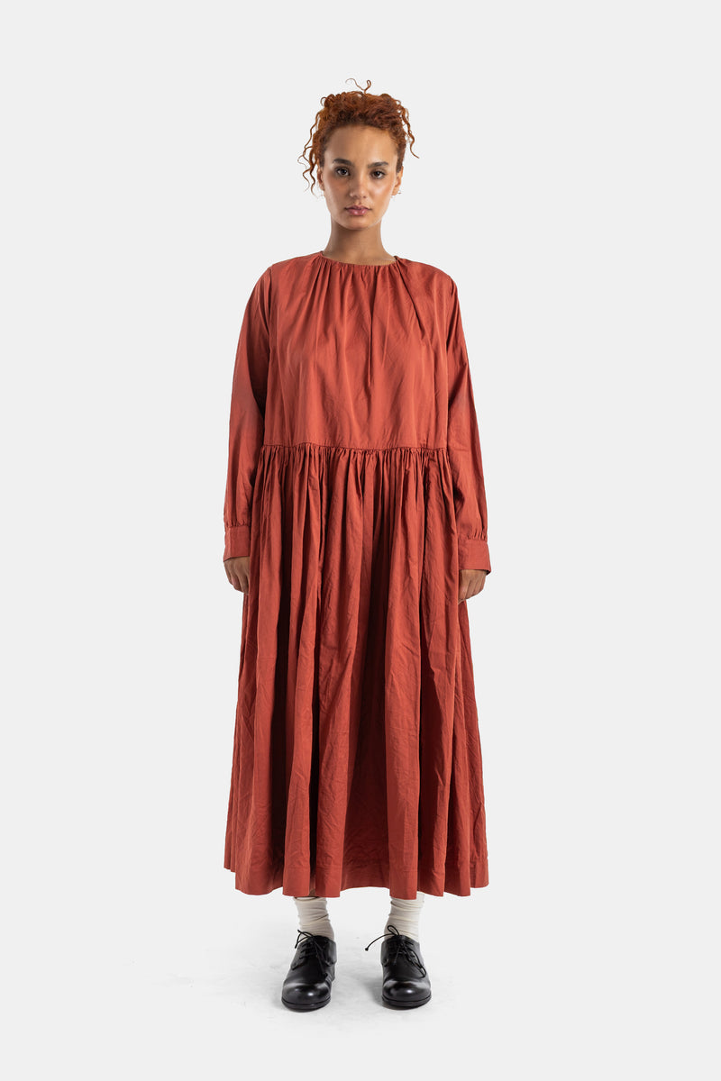Casey Casey loose Pomme dress featuring a boat neck and gathered long sleeves in brick terracotta cotton.