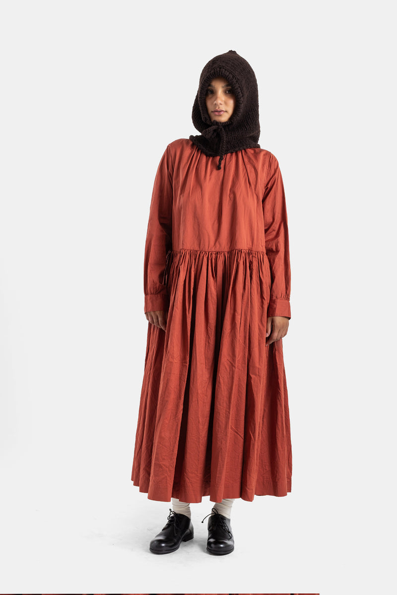 Casey Casey Pomme Rouche dress worn with brown knit balaclava and black derbies, flared gathered brick skirt.