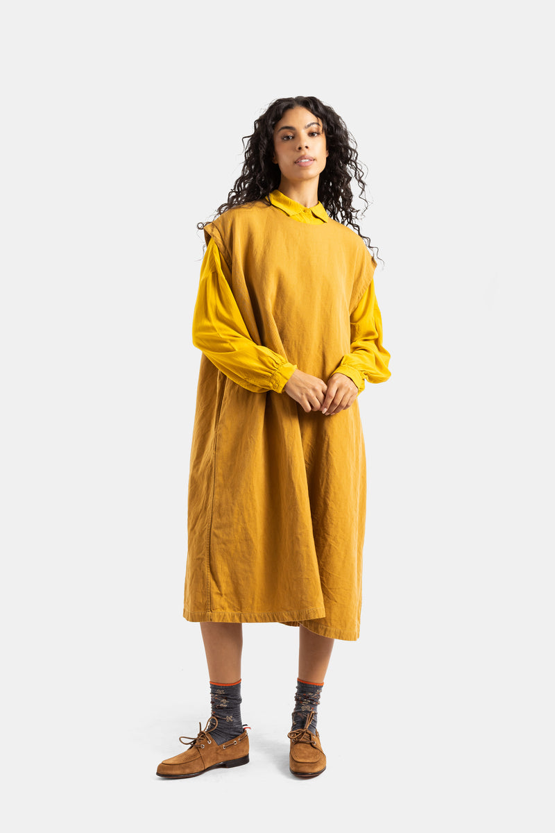 Casey Casey mustard Valeme dress styled with grey socks and camel loafers, for an elegant casual look.